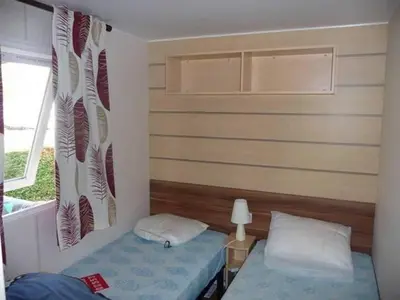 Un ou plusieurs lits dans un hébergement de l'établissement Mobil Home