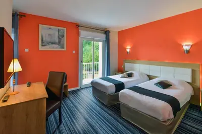 Un ou plusieurs lits dans un hébergement de l'établissement Contact Hotel Le Moulin Neuf Chantonnay