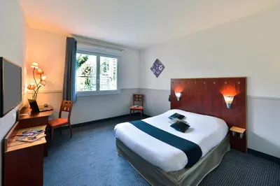 Un ou plusieurs lits dans un hébergement de l'établissement Contact Hotel Le Moulin Neuf Chantonnay