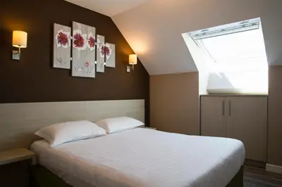 Un ou plusieurs lits dans un hébergement de l'établissement Park Hôtel & Appartements