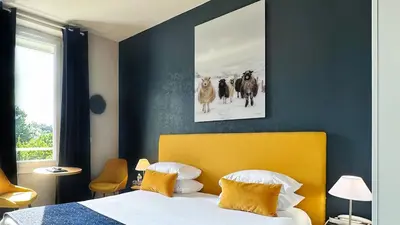 Un ou plusieurs lits dans un hébergement de l'établissement Hôtel Coeur De Loire