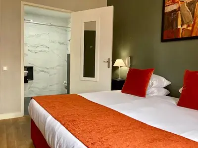 Un ou plusieurs lits dans un hébergement de l'établissement Hôtel Coeur De Loire