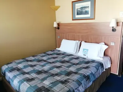 Un ou plusieurs lits dans un hébergement de l'établissement Kyriad Angers Sud Ponts-De-Cé
