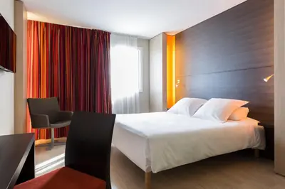 Un ou plusieurs lits dans un hébergement de l'établissement Hôtel Oceania Nantes Aéroport