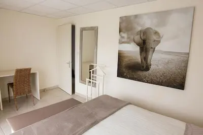 Un ou plusieurs lits dans un hébergement de l'établissement Chambres Au Jardin Fleuri