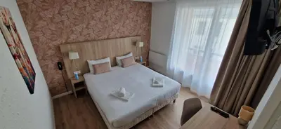 Un ou plusieurs lits dans un hébergement de l'établissement Cit'Hôtel Le Quai 9