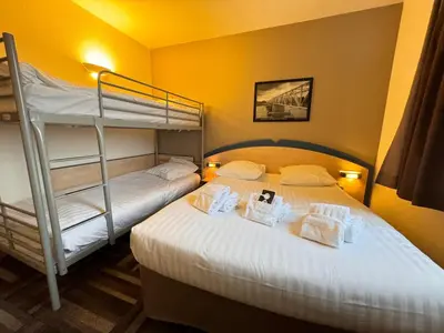 Un ou plusieurs lits dans un hébergement de l'établissement Le 2 by Hotel Akena - Nantes Beaujoire, Porte de Sainte Luce
