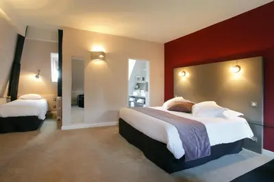 Un ou plusieurs lits dans un hébergement de l'établissement Hotel Château de la Barbinière