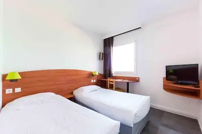Un ou plusieurs lits dans un hébergement de l'établissement Hôtel AKENA Nantes Orvault - Ouest