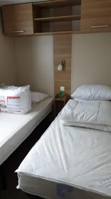 Un ou plusieurs lits dans un hébergement de l'établissement Mobil-home Confort camping le bois Masson