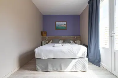 Un ou plusieurs lits dans un hébergement de l'établissement Maison Esperanza hôtel et appartement