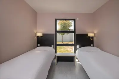 Un ou plusieurs lits dans un hébergement de l'établissement Village by logis