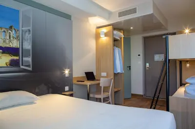 Un ou plusieurs lits dans un hébergement de l'établissement B&B HOTEL Les Herbiers