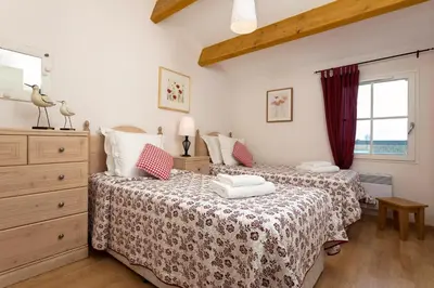 Un ou plusieurs lits dans un hébergement de l'établissement Madame Vacances Les Villas de Fontenelles