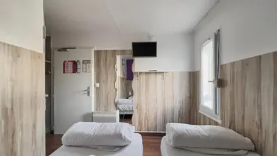 Un ou plusieurs lits dans un hébergement de l'établissement Fasthotel La Roche-sur-Yon Un FH CONFORT