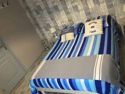 Un ou plusieurs lits dans un hébergement de l'établissement Les chambres du roc