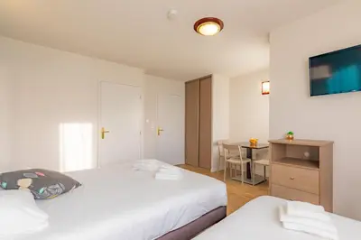 Un ou plusieurs lits dans un hébergement de l'établissement Appart'City Classic La Roche sur Yon Centre