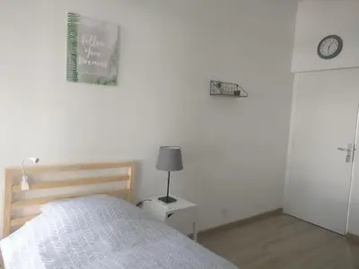 Un ou plusieurs lits dans un hébergement de l'établissement Appart Hôtel L'Angélique