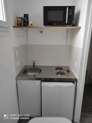 Cuisine ou kitchenette dans l'établissement Appart Hôtel L'Angélique