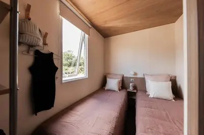 Un ou plusieurs lits dans un hébergement de l'établissement Camping OAKi