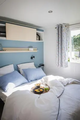Un ou plusieurs lits dans un hébergement de l'établissement Camping OAKi