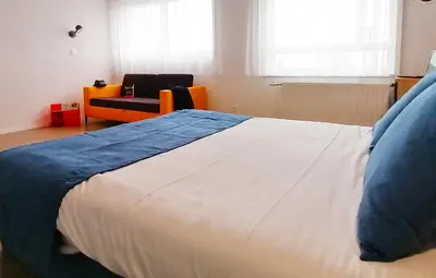 Un ou plusieurs lits dans un hébergement de l'établissement Appart-Hotel Mer & Golf City Ile de Nantes