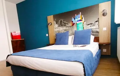 Un ou plusieurs lits dans un hébergement de l'établissement Appart-Hotel Mer & Golf City Ile de Nantes