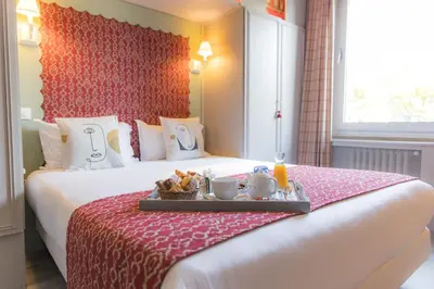 Un ou plusieurs lits dans un hébergement de l'établissement Hotel de Charme Le Sud Bretagne