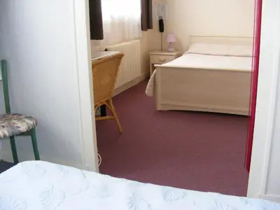 Un ou plusieurs lits dans un hébergement de l'établissement Hotel du Commerce