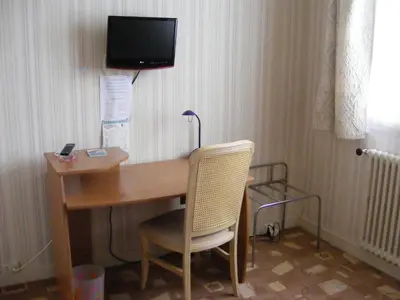 Télévision ou salle de divertissement dans l'établissement Hotel du Commerce