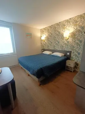 Un ou plusieurs lits dans un hébergement de l'établissement Hotel Restaurant L'Atlantique