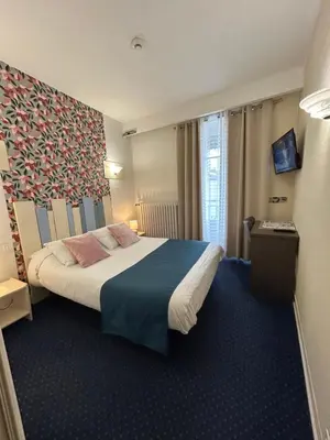 Un ou plusieurs lits dans un hébergement de l'établissement Hôtel Le Centre