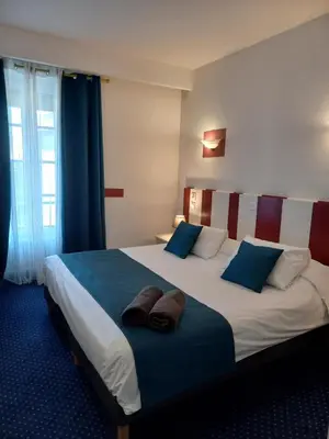 Un ou plusieurs lits dans un hébergement de l'établissement Hôtel Le Centre