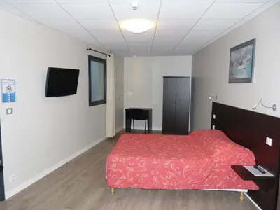 Télévision ou salle de divertissement dans l'établissement Hôtel Terminus