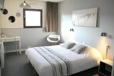 Un ou plusieurs lits dans un hébergement de l'établissement Bel Hotel