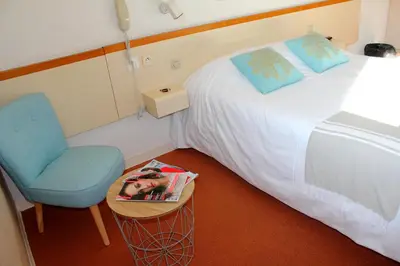 Un ou plusieurs lits dans un hébergement de l'établissement Bel Hotel
