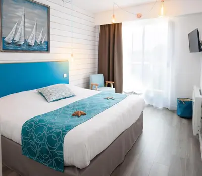 Un ou plusieurs lits dans un hébergement de l'établissement Hotel La Cote Oceane - Saint Jean de Monts