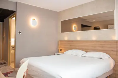 Un ou plusieurs lits dans un hébergement de l'établissement Brit Hotel Nantes Vigneux - L'Atlantel