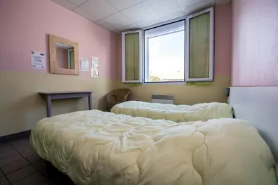 Un ou plusieurs lits dans un hébergement de l'établissement LE SOLEIL DE JADE village vacances