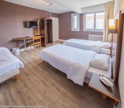 Un ou plusieurs lits dans un hébergement de l'établissement Hôtel de la Vendée
