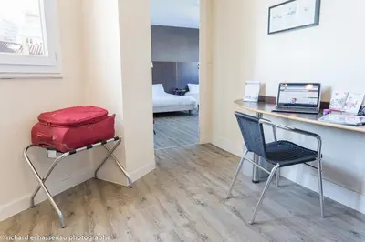 Un ou plusieurs lits dans un hébergement de l'établissement Hôtel de la Vendée