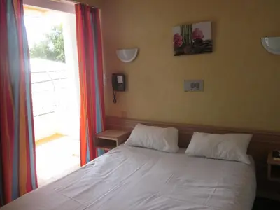 Un ou plusieurs lits dans un hébergement de l'établissement Hotel La Chaumière