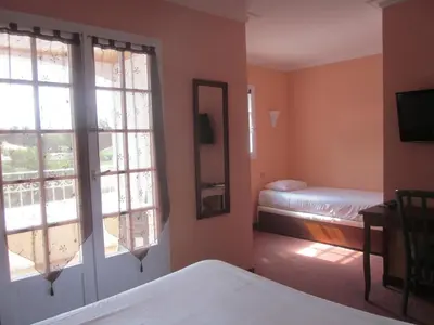 Un ou plusieurs lits dans un hébergement de l'établissement Hotel La Chaumière