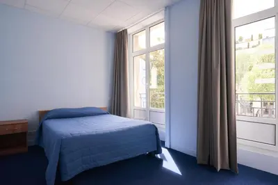 Un ou plusieurs lits dans un hébergement de l'établissement Hotel Le Petit Duquesne
