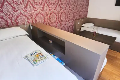 Un ou plusieurs lits dans un hébergement de l'établissement Hotel Le Petit Duquesne