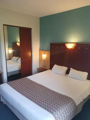 Un ou plusieurs lits dans un hébergement de l'établissement Logis Hotel De La Loire Ancenis - Restaurant Les Bateliers