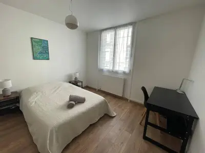 Un ou plusieurs lits dans un hébergement de l'établissement Appartement Spacieux Centre Gare Visitation