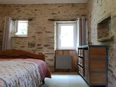 Un ou plusieurs lits dans un hébergement de l'établissement Gîte les genêts