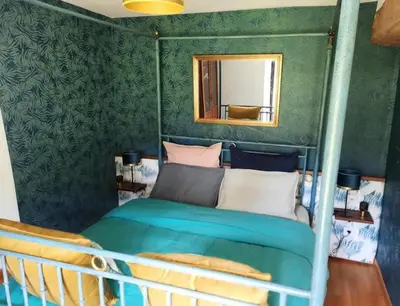Un ou plusieurs lits dans un hébergement de l'établissement Gîte et Chambres d'Hôtes du Petit Moulin