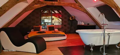Coin salon dans l'établissement Apparthotel loft Martigné-Ferchaud